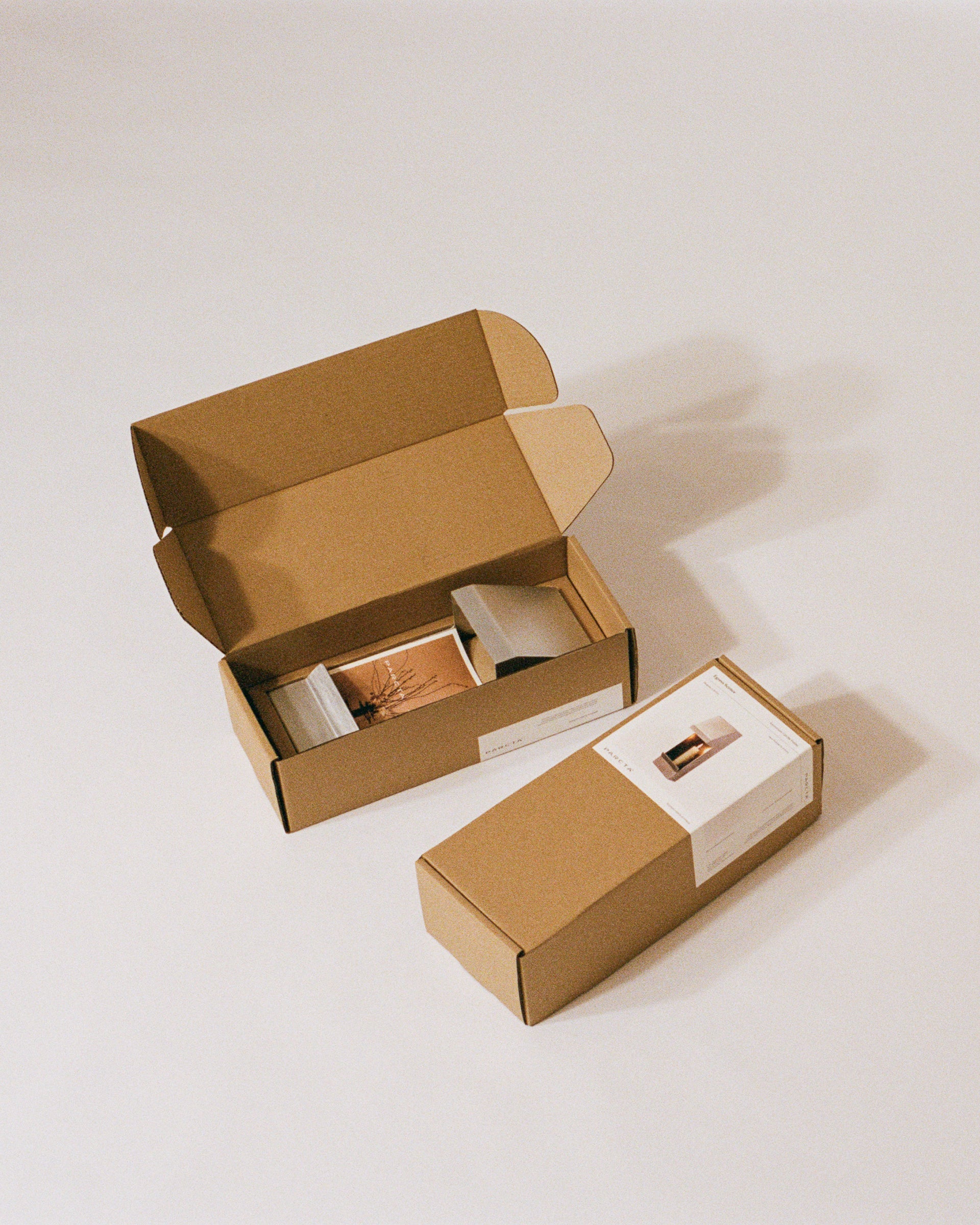 Inside of the packaged candle holder box by PARCTA on a neutral background.