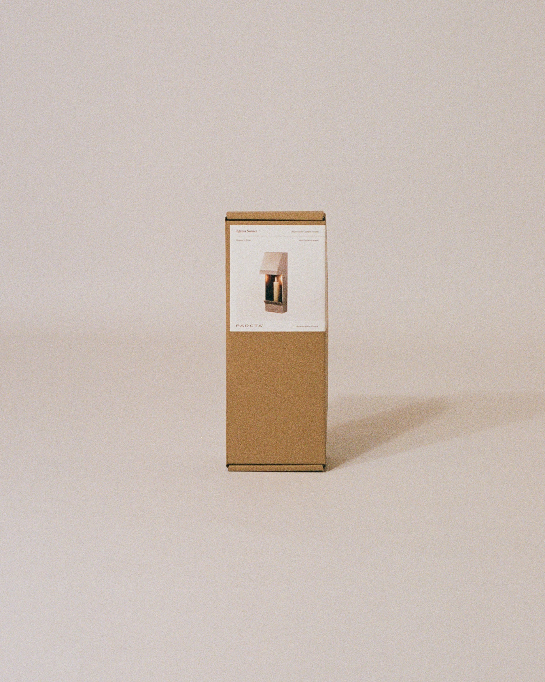 The packaged candle holder box by PARCTA on a neutral background.