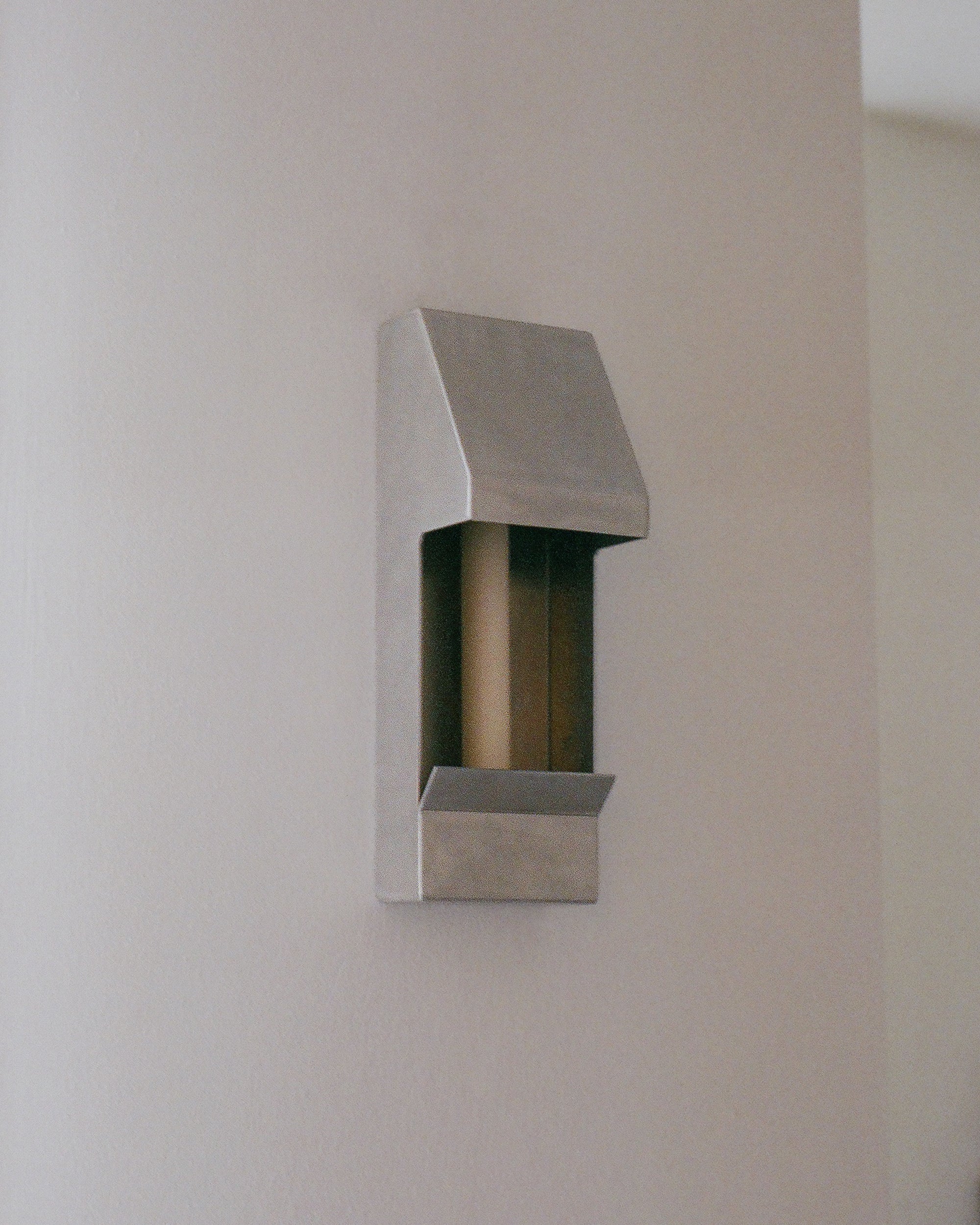Candle holder by PARCTA with an unlit candle inside on a neutral background.