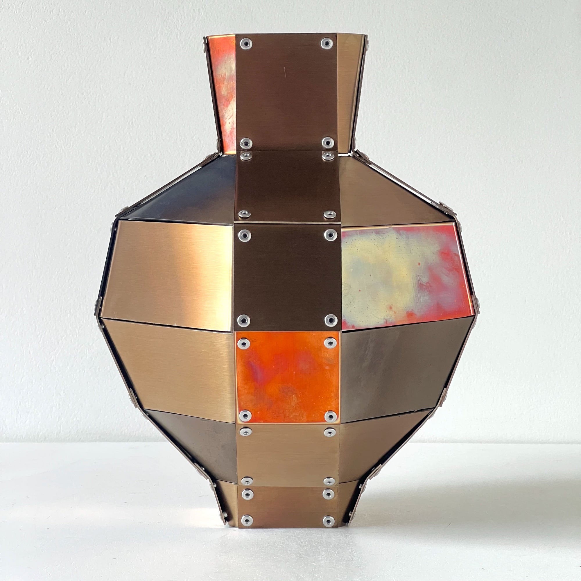 Stainless steel and copper decorative object by Theo Galliakis on a white background.