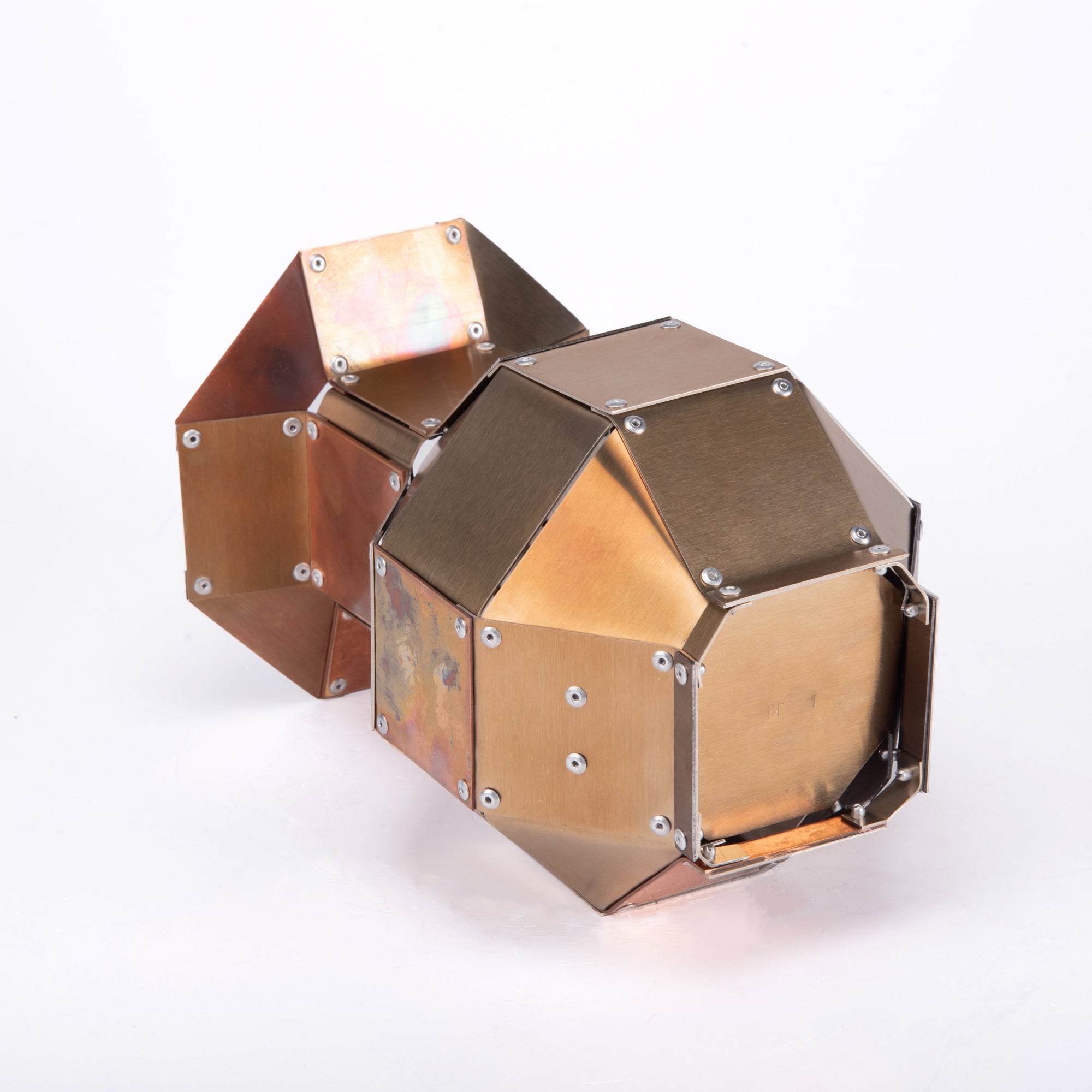 Base of a stainless steel and copper decorative object by Theo Galliakis on a white background.