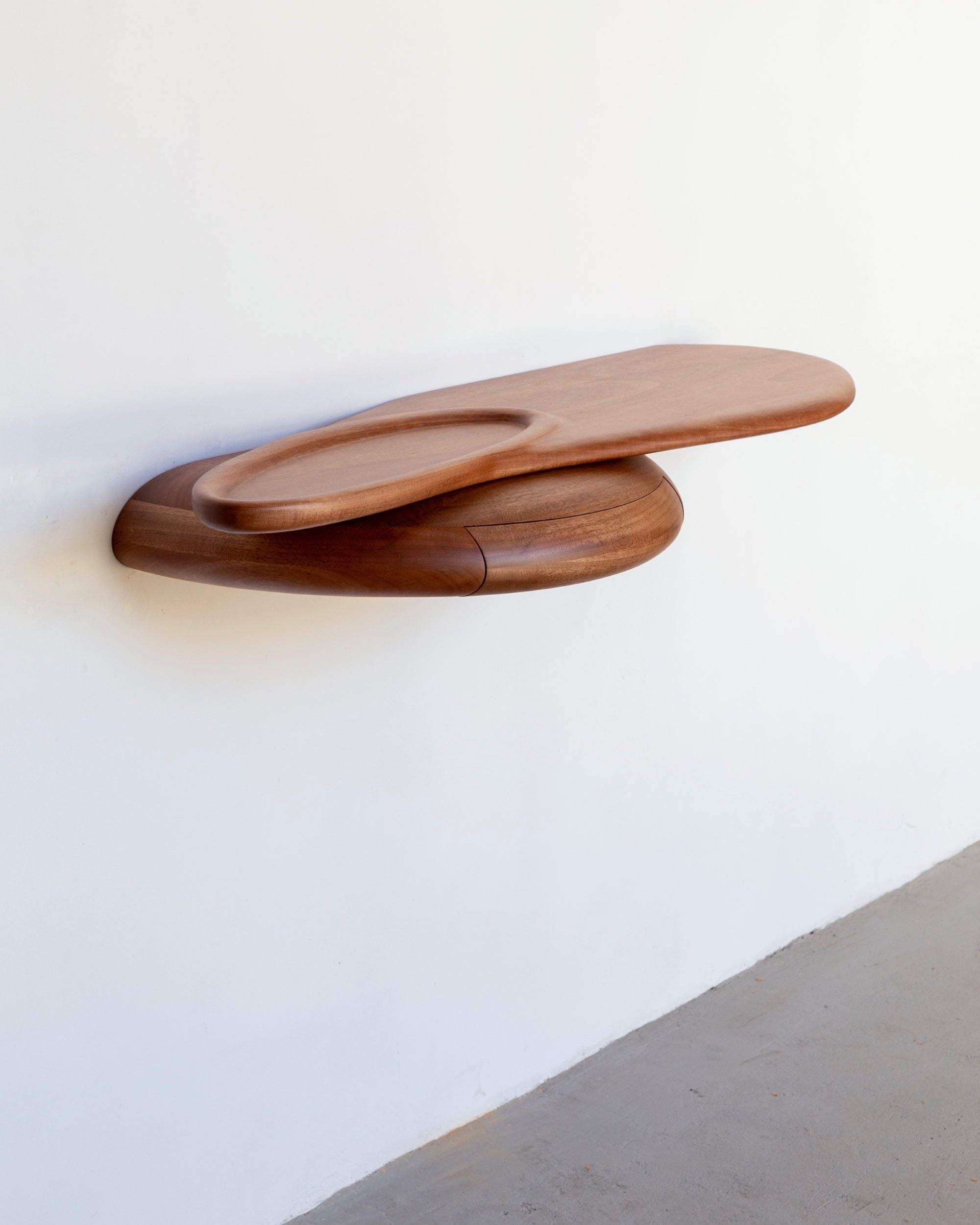 Shelf by Estudio Prosa on a white wall with grey industrial floor.