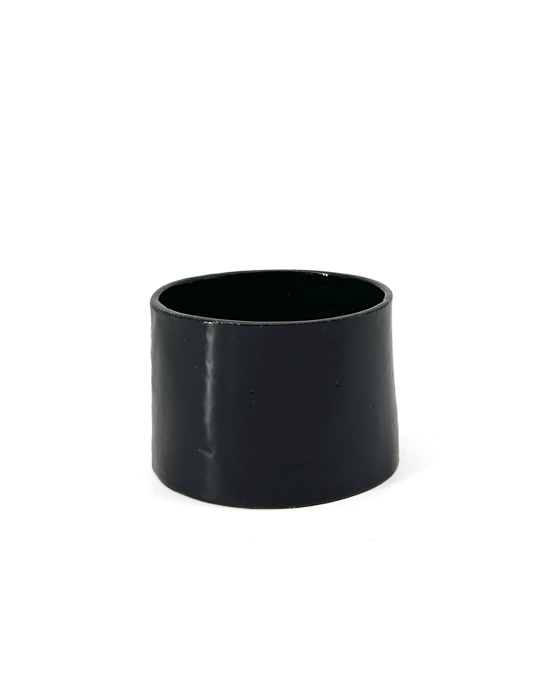 Black, glossy ceramic coffee cup by klangnapha on a white background.