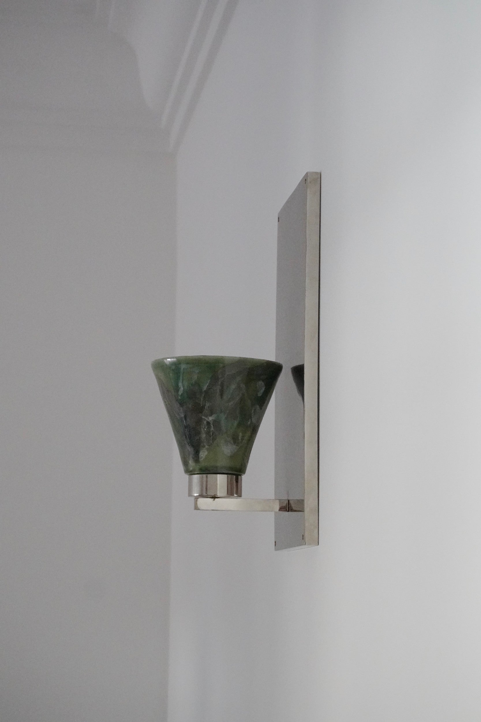 Side angle of Vetra Lamp by Marta Cypel, mounted on a white wall.