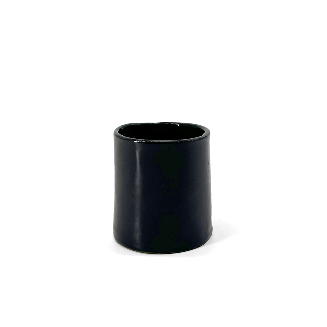 Black, glossy ceramic espresso cup by klangnapha on a white background.