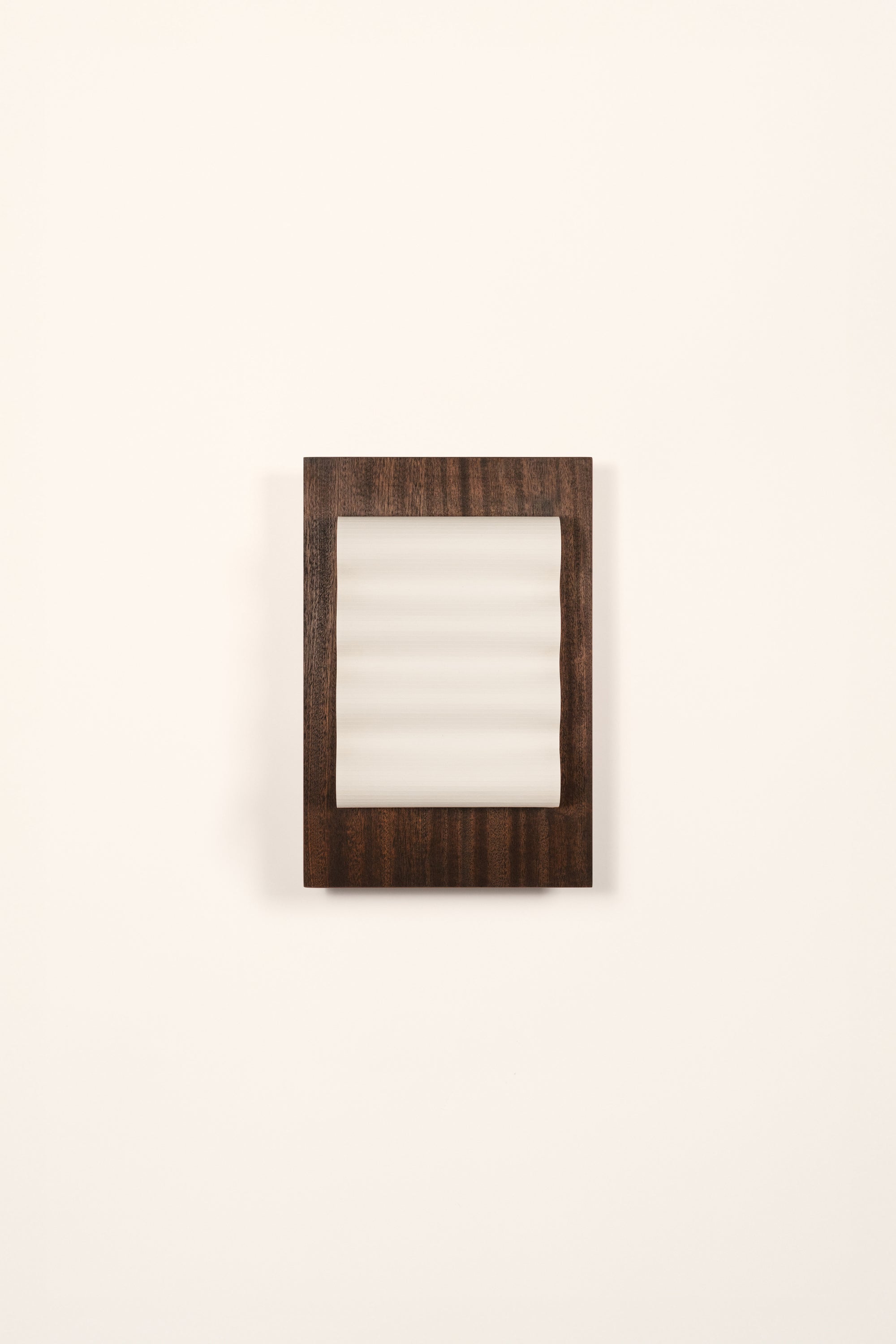 Framed wall light fixture in wood with a paper shade by Violaine d'Harcourt on a white background with light off.