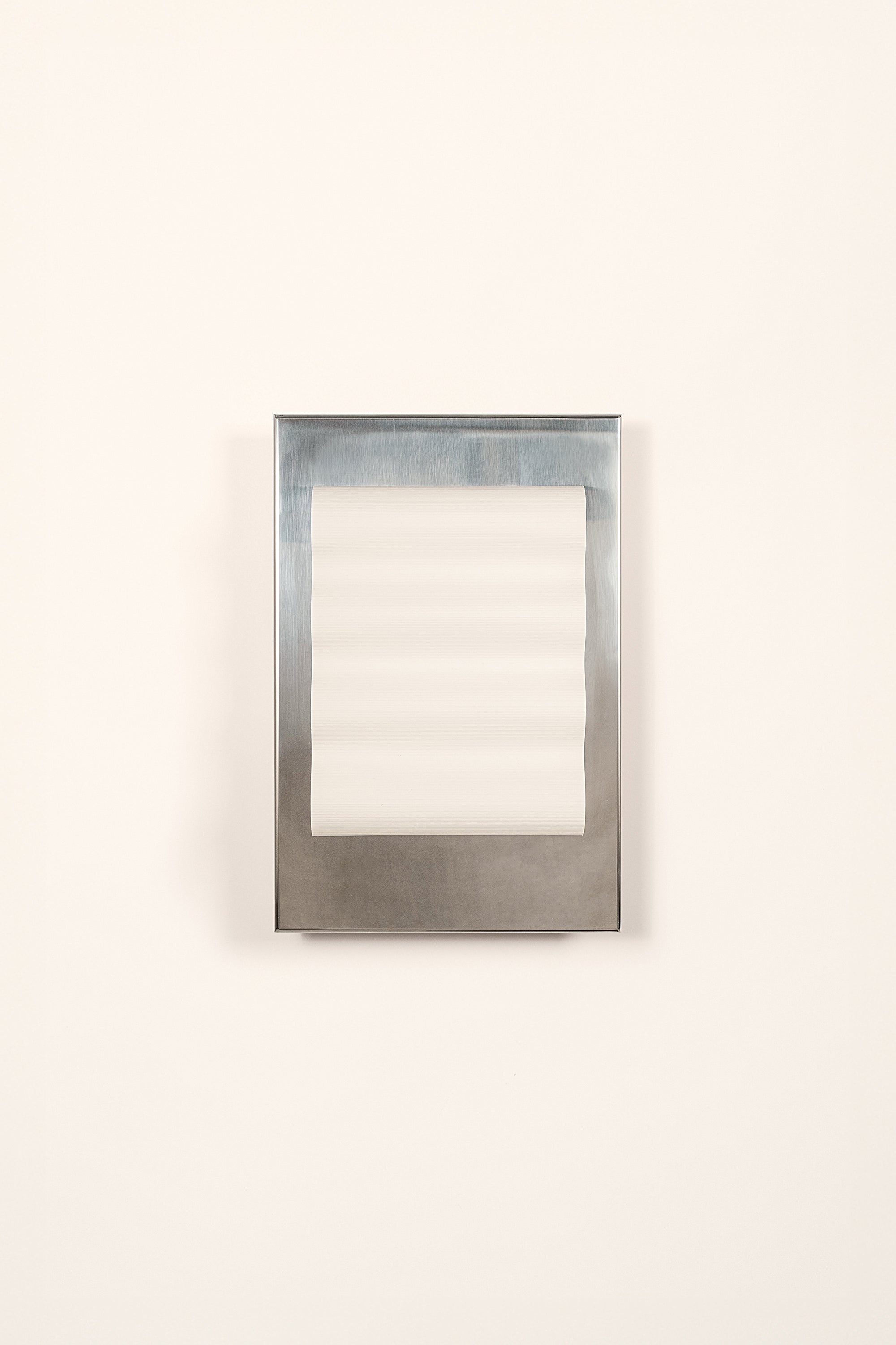 Framed wall light fixture in polished stainless steel with a paper shade by Violaine d'Harcourt on a white background with light off.