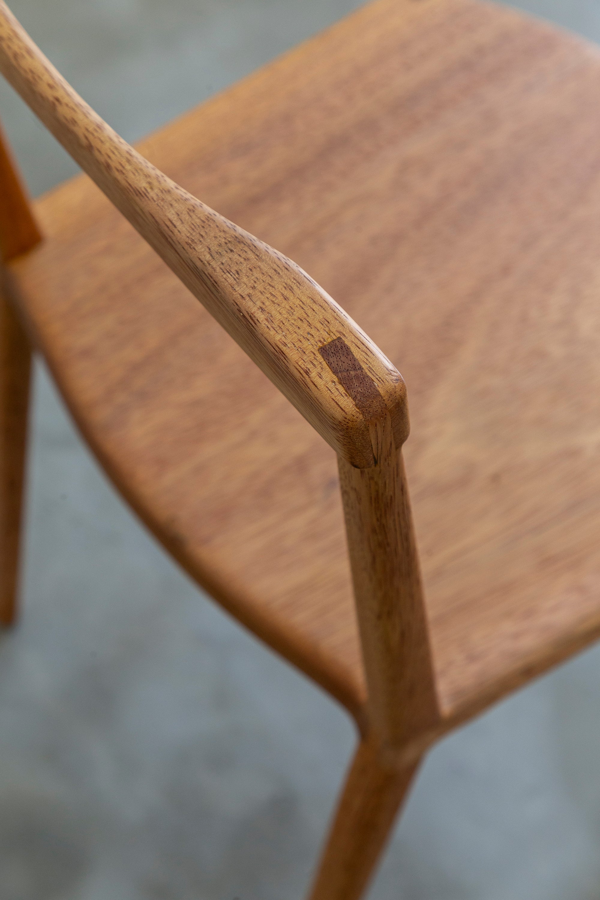 Close up of wooden chair by Estudio Prosa with a blurred background.