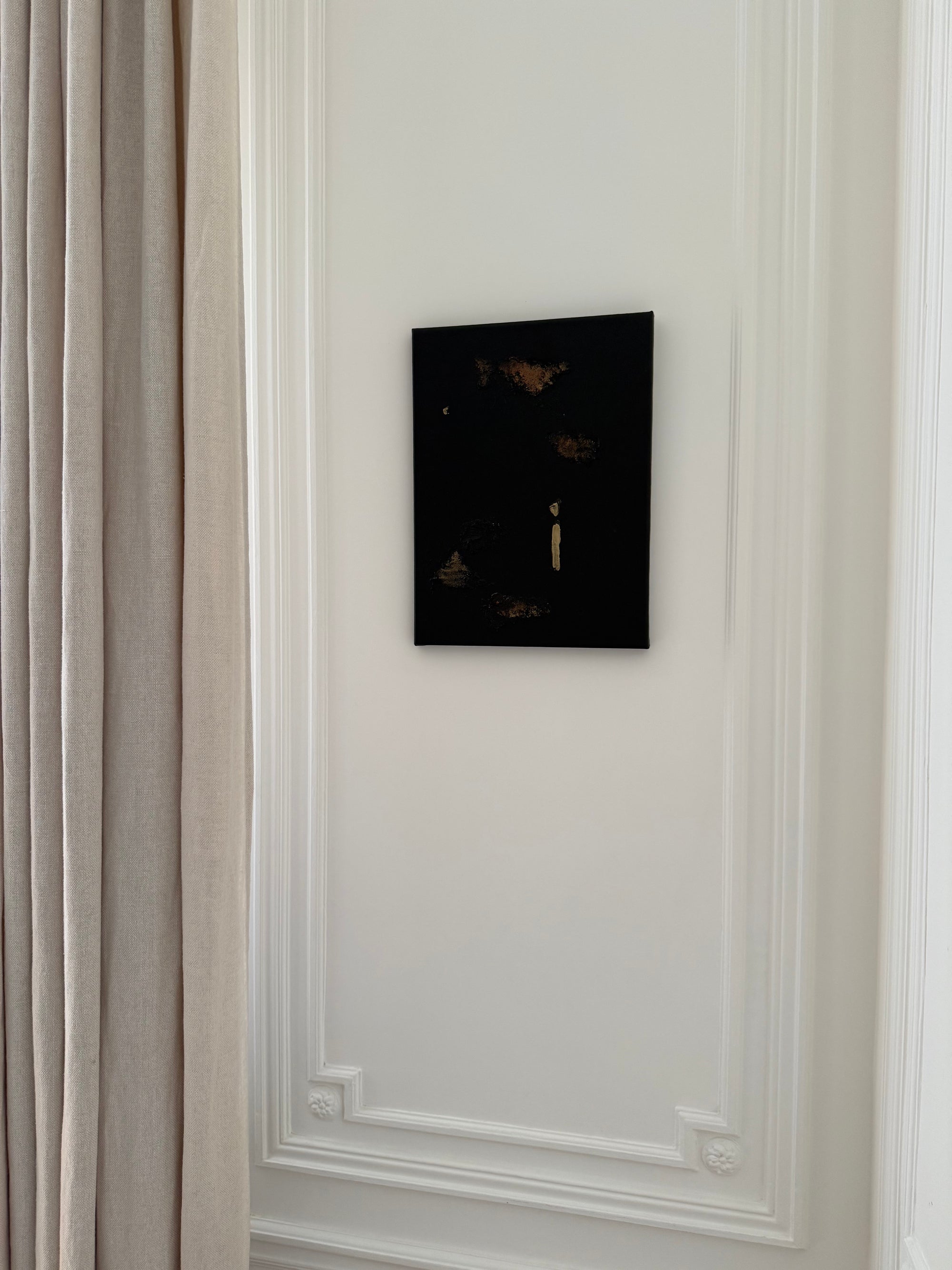Gold and brown decorative abstract wall by Noelia Hobeika displayed on a decorative wall with a beige curtain alongside it.