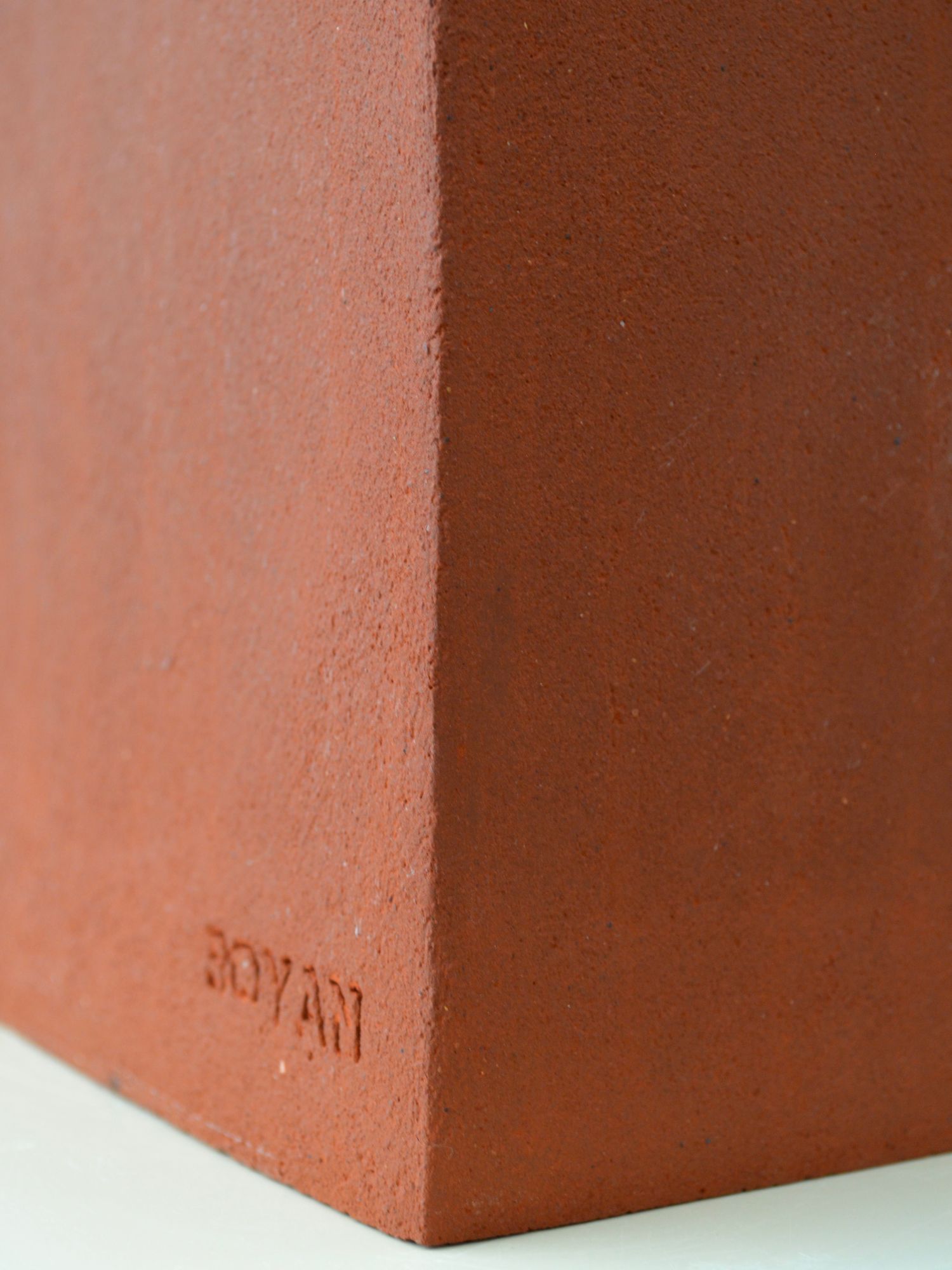 Close up of ceramic lamp by Zeynep Boyan with Boyan branding engraved on the bottom right corner.