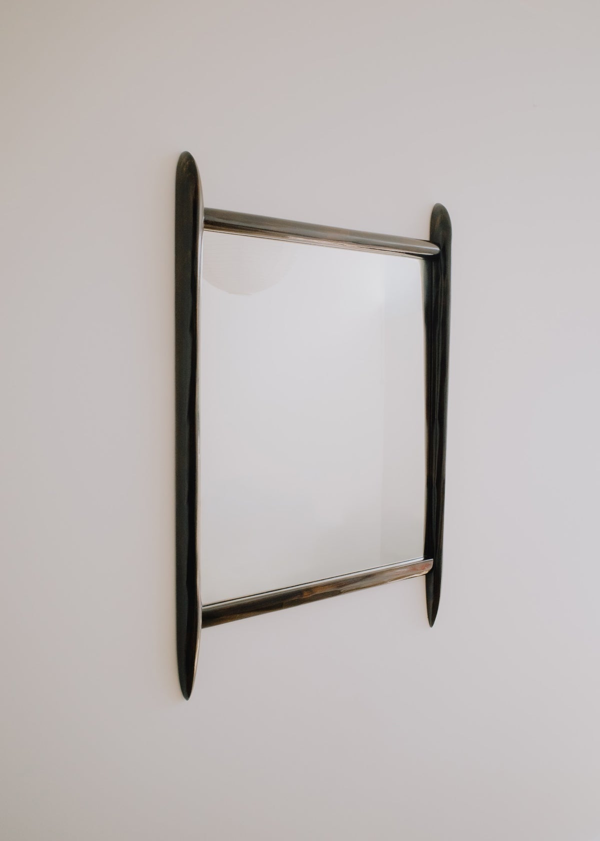 Glade mirror by Calum Stevens hanging on a neutral wall.