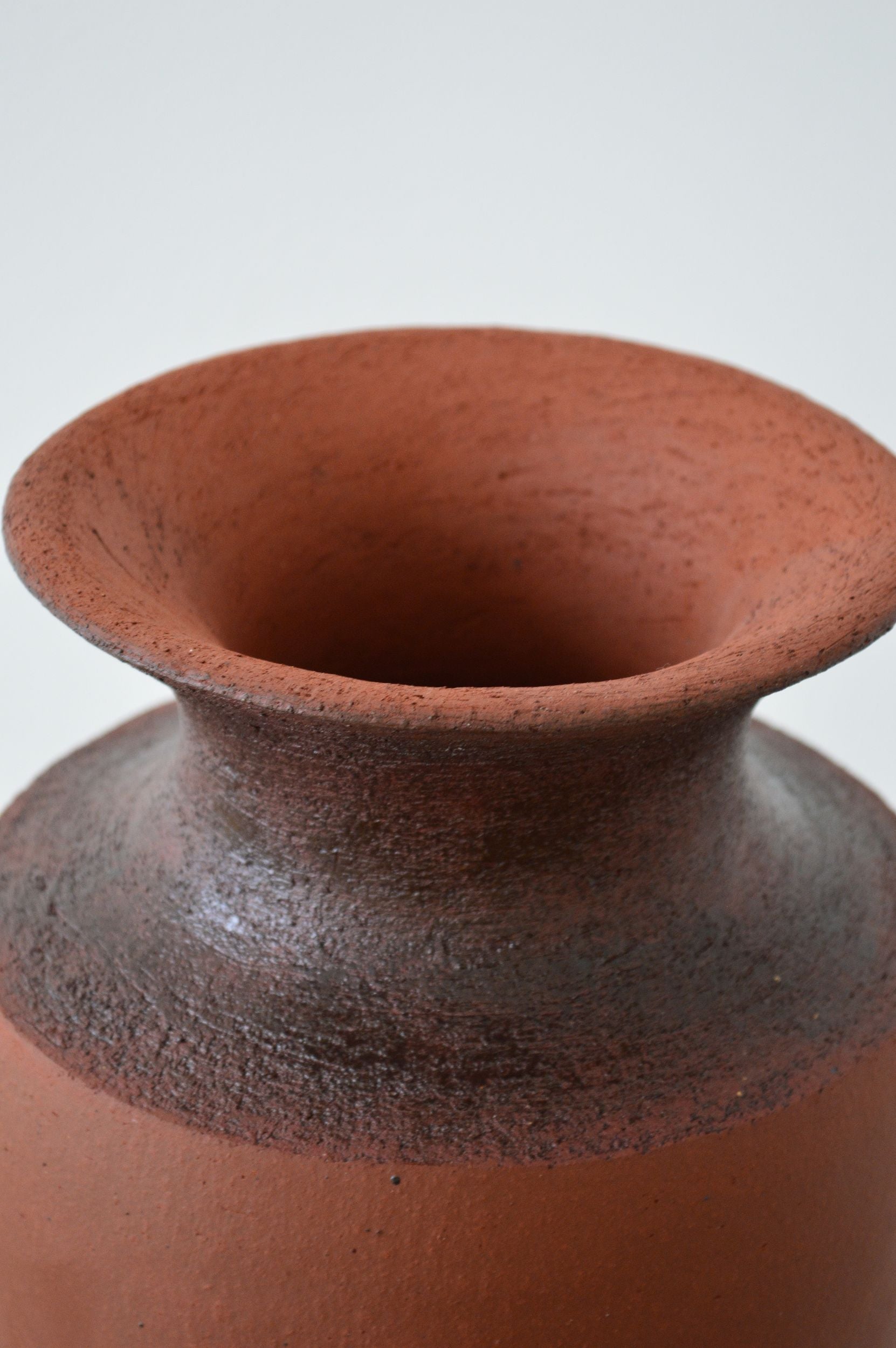 Close up of a terra cotta clay vase by Zeynep Boyan.