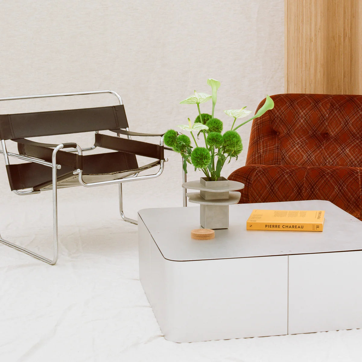 Coffee Table and vase by PARCTA sat in a living room setting. 