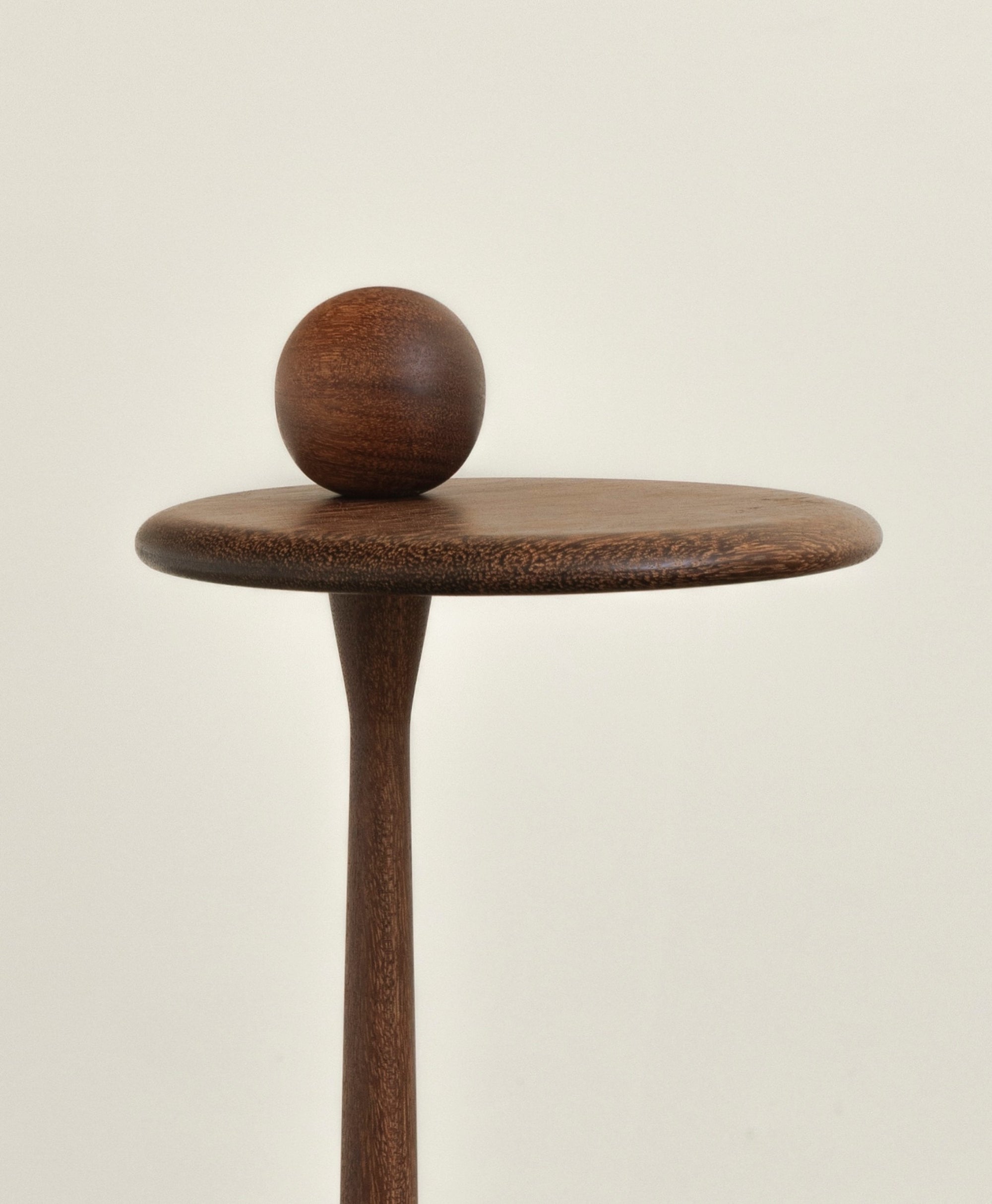 Close up of wooden side table on a white background by Estudio Prosa.