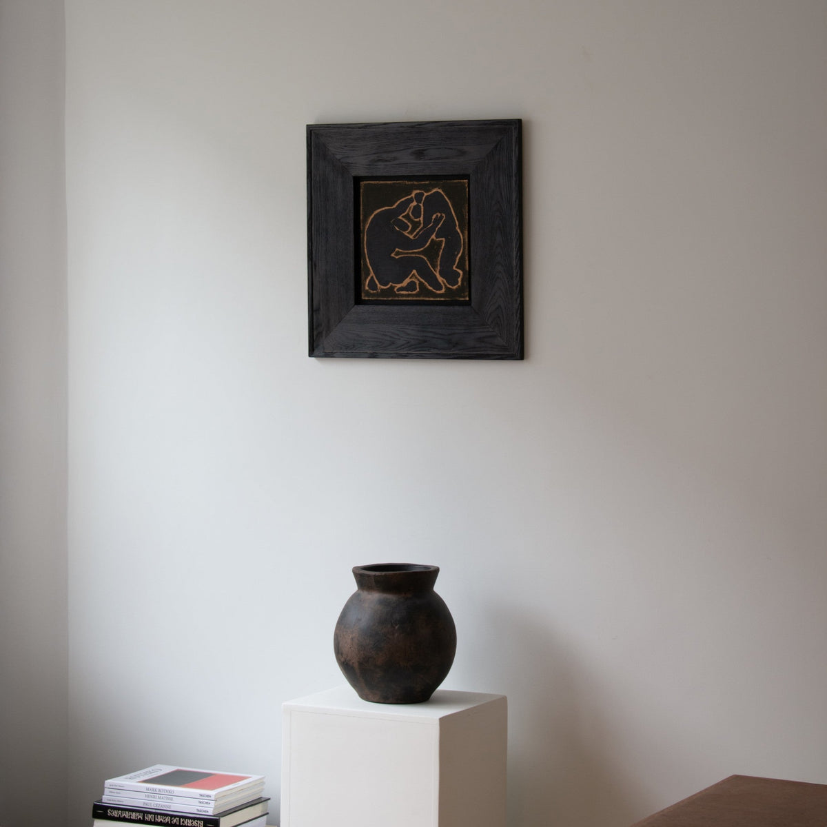 Original framed wall art by Marcsen displayed on a neutral wall above a white pedestal with a dark ceramic vase.