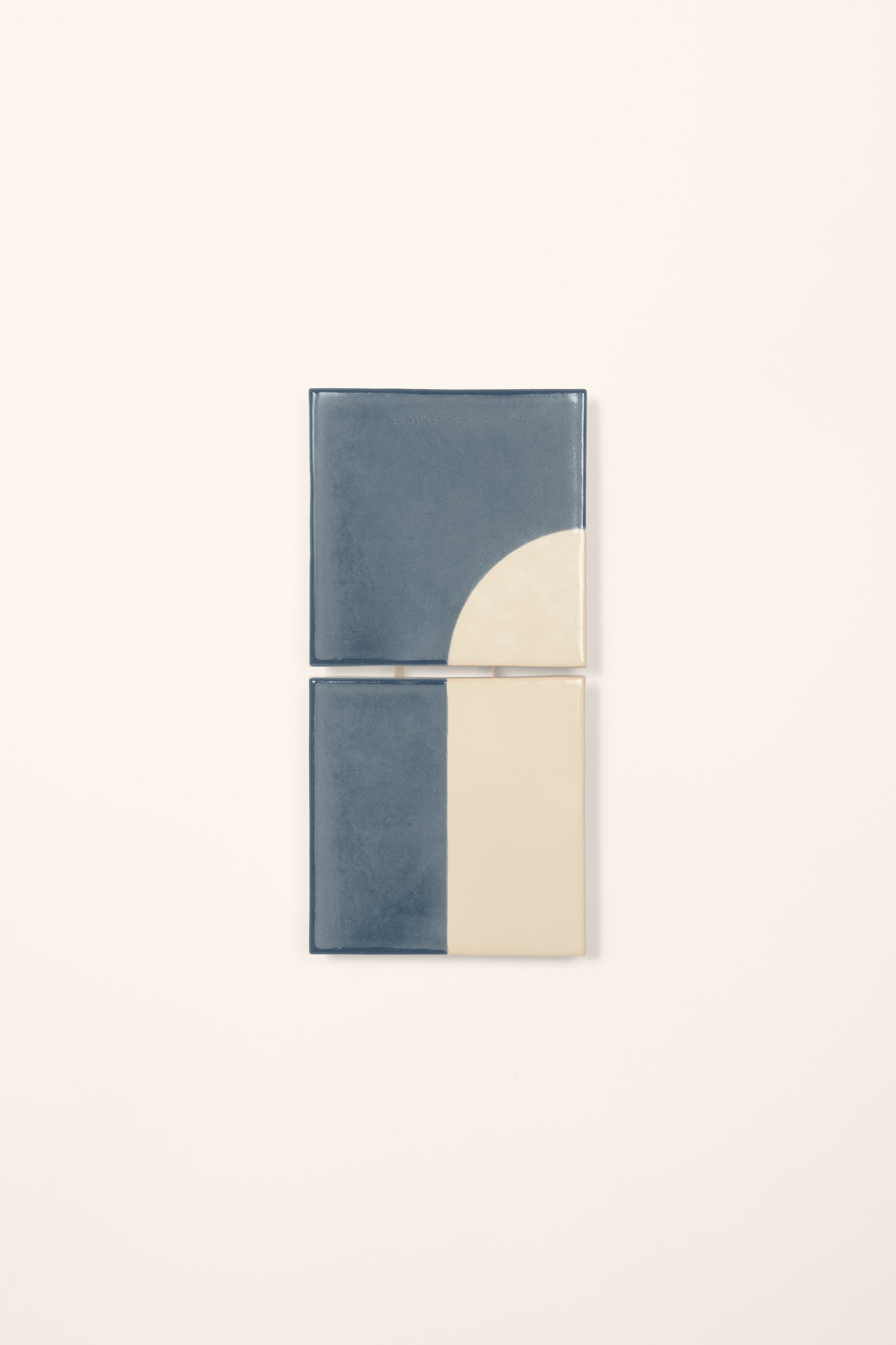 Wall-mounted light fixture by Violaine d'Harcourt with the light off. The design is a geometric pattern in blue and white with a neutral background.