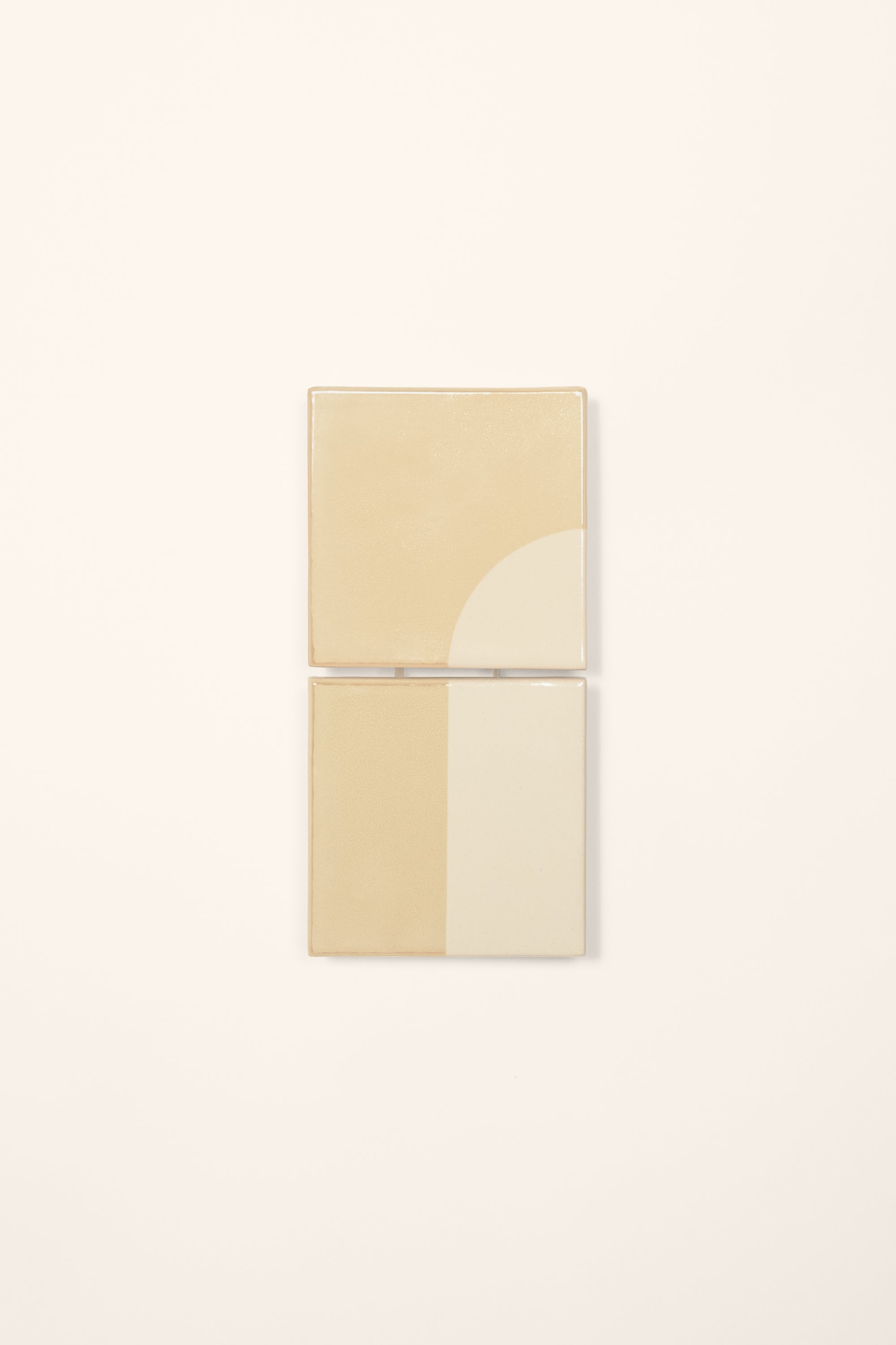 Wall-mounted light fixture by Violaine d'Harcourt with the light off. The design is a geometric pattern in cream and white with a neutral background.