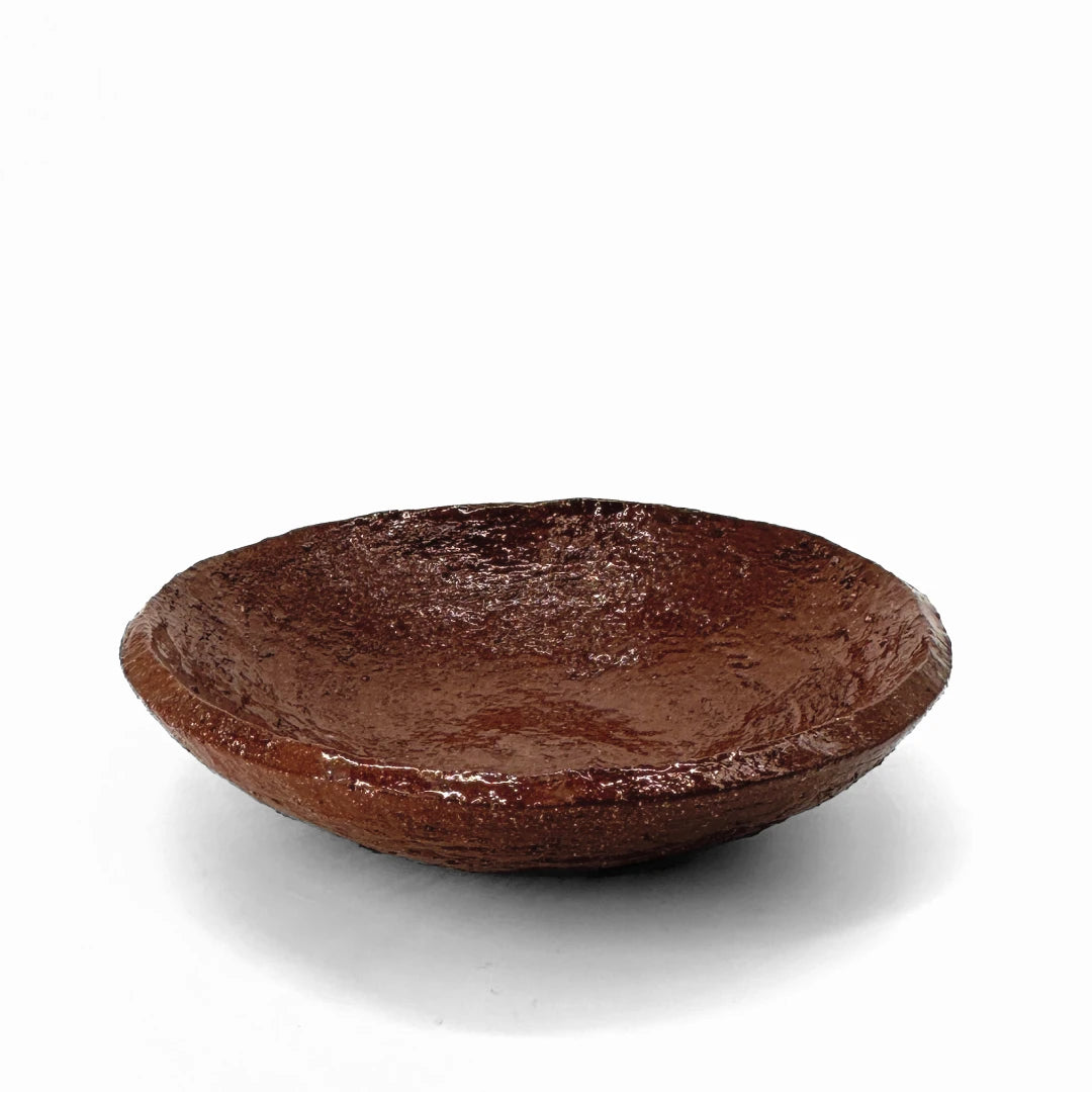 Terracotta bowl by klangnapha finished with a shiny, transparent glaze on a white background.